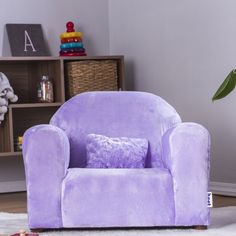 a purple chair sitting on top of a white rug