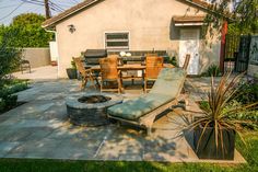 a patio with an outdoor fire pit and table