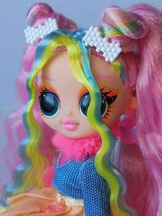 a close up of a doll with colorful hair