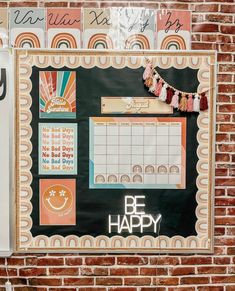 a brick wall with a bulletin board on it that says be happy written in large letters