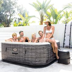 a group of people sitting in an outdoor hot tub