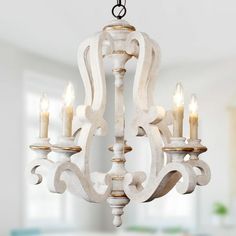 a white chandelier with candles hanging from it