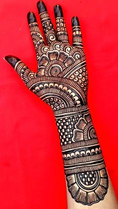 a hand with henna tattoos on it