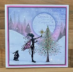 a christmas card featuring a girl and her cat in the snow with a tree on it