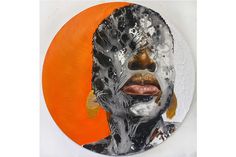 an orange and white circle with a painting of a woman's face