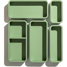 four green trays sitting on top of each other in the shape of rectangles