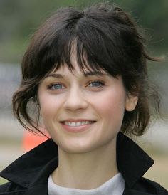 a close up of a person smiling at the camera