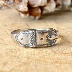 Designed to resemble a miniature belt buckle, this ring is not just an accessory but a statement. Whether you're looking for a bold thumb ring or a standout gift for someone special, this piece delivers. Its versatile design makes it an ideal gift for both him and her, perfect for those who appreciate a touch of the Wild West in their wardrobe. So, saddle up and let this ring add a bit of cowboy spirit to your jewelry collection. Ideal for birthdays, anniversaries, or just because, this sterling Urban Cowgirl, Buckle Ring, Bracelet Size Chart, Thumb Rings, Ring Sizer, Earring Necklace, Ring Necklace, Belt Buckles, Jewelry Sales