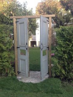 an open door in the middle of a garden