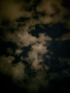 the night sky is filled with clouds and stars