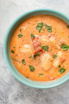 a blue bowl filled with soup on top of a table