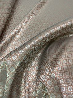 a close up view of a fabric with brown and white squares on it's surface