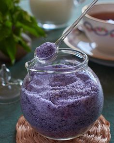 a glass jar filled with purple powder on top of a table