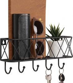 a black metal shelf with keys, wallets and other items hanging from it's hooks