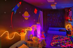 a bedroom decorated in bright colors with lights on the walls and rugs around it