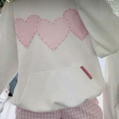 the hoodie has hearts on it and is white with pink gingham checks