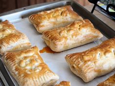 several pastries are being cooked on a baking sheet