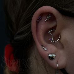 an ear with three different types of piercings on it