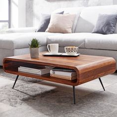 a coffee table sitting on top of a rug next to a couch