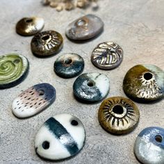 there are many different types of buttons on the table together, including one with an eye