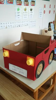 a cardboard box shaped like a car on a table