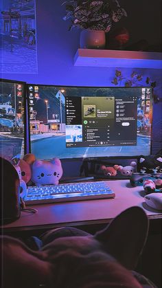 a person sitting in front of a computer monitor with a keyboard and mouse on it