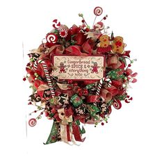 a christmas wreath with candy canes, candies and other holiday decorations on it