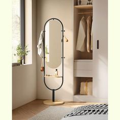 a large mirror sitting on top of a stand next to a closet filled with clothes