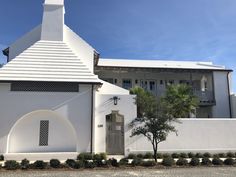 a large white building with a clock on it's side