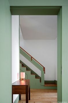 an empty room with stairs and a table