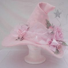 a pink hat with flowers and pearls on it