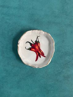 a red chili pepper on a white plate