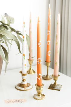 five candles are lined up on a table