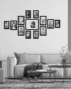 a living room filled with furniture and framed pictures on the wall above a coffee table