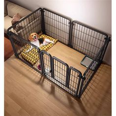 a dog is laying in its cage on the floor