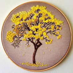 a yellow embroidered tree is shown in the hoop