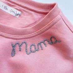 a pink shirt with the word mom written on it