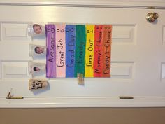 the door is decorated with colorful signs and magnets for each child's name