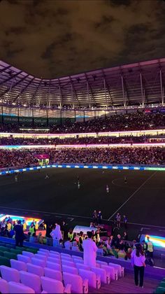 a stadium filled with lots of people sitting on the bleachers and watching soccer