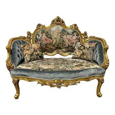 an ornate gold and blue couch with flowers on it