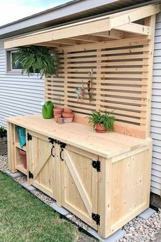 a wooden bench with potted plants on top