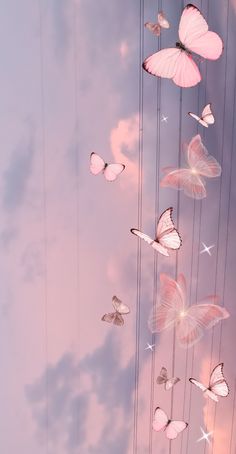 several pink butterflies flying in the sky with clouds and stars above them, all connected by strings