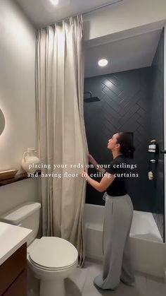 a woman standing in front of a shower next to a toilet and bathtub with the caption, placing your rod on your ceilings and having floor to ceiling curtains