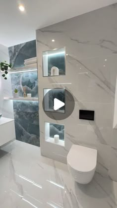 a modern bathroom with white marble walls and flooring is featured in this video showing how to use the toilet