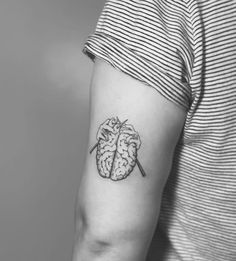 a black and white photo of a person with a tattoo on their arm