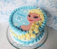 a frozen princess cake on a glass plate