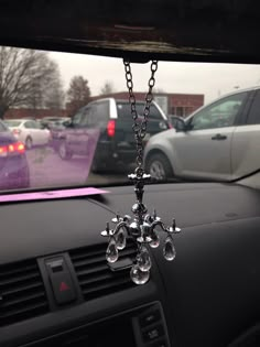 a crystal chandelier hanging from the dashboard of a car