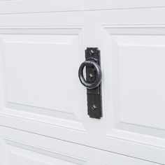 a close up of a white door with a black handle on the front and side