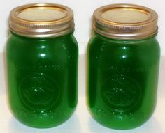 two green jars with gold lids sitting side by side