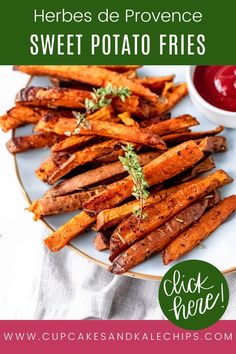 baked sweet potato fries on a plate with ketchup and sauce in the background